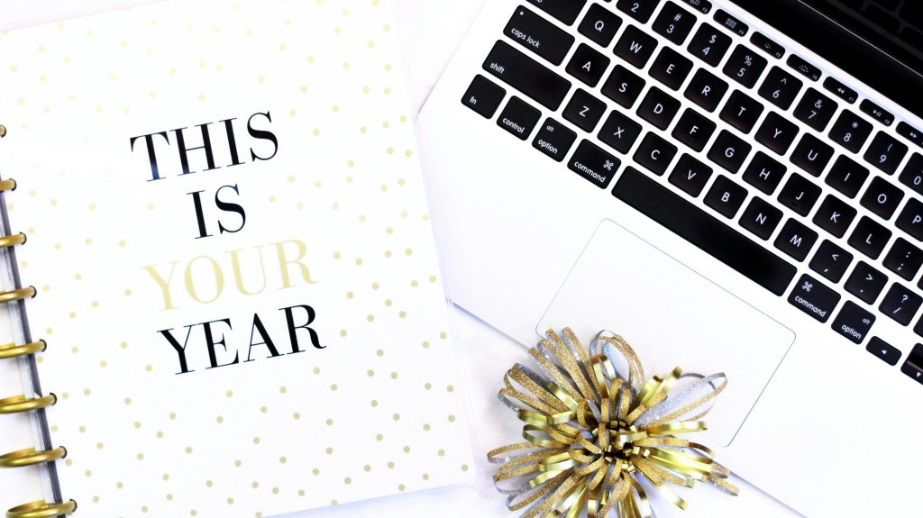 This is your year text on book near laptop