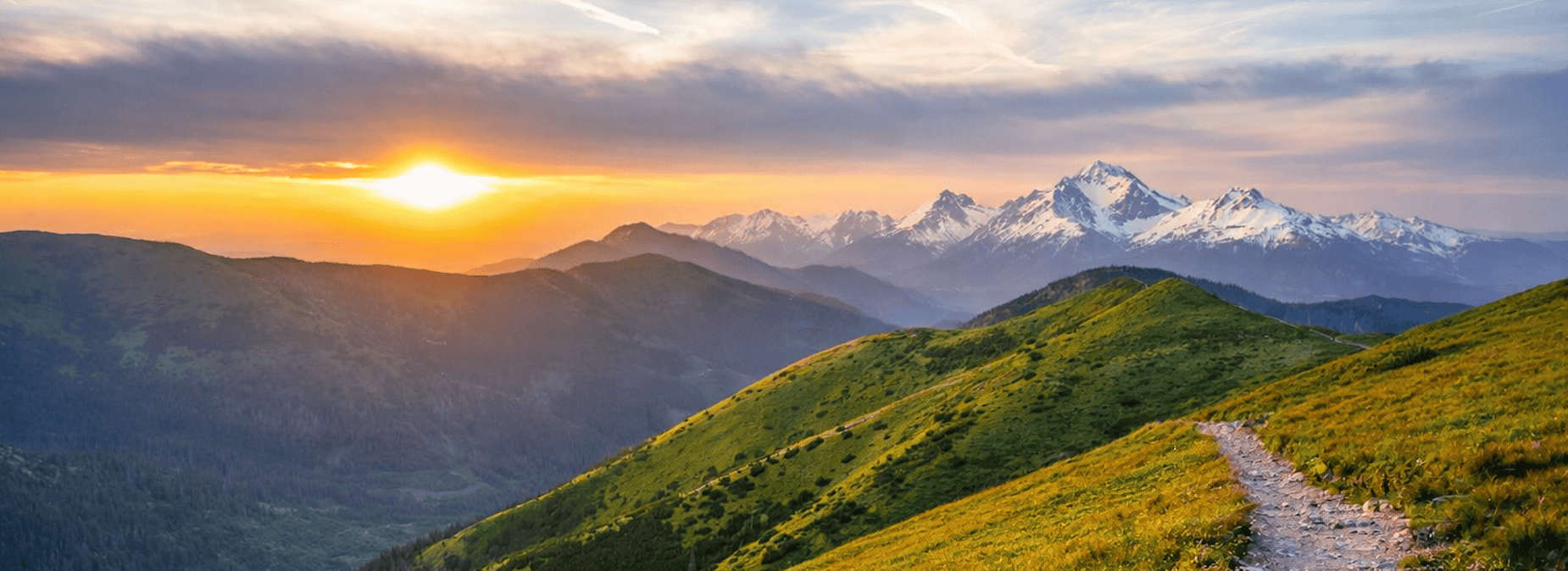 A mountain path stretched to a sunrise horizon.